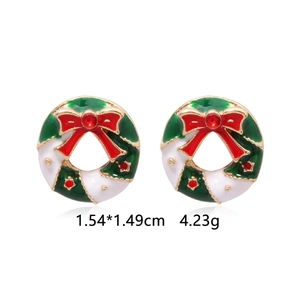 Detailed view of enamel Christmas wreath studs with red rhinestone and gold trim
