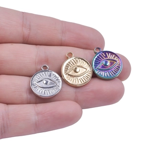 Three stainless steel evil eye pendant charms in gold, silver, and rainbow colors
