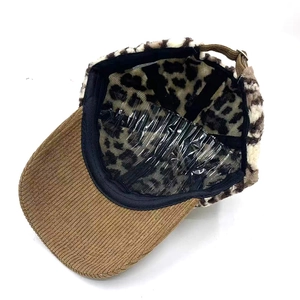 Leopard print baseball cap detail showing warm faux fur and adjustable metal buckle strap