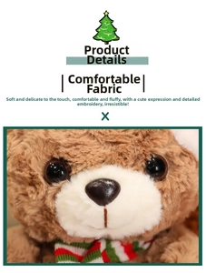 Close-up of curly brown plush bear with red and green striped knit scarf for Christmas