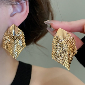 Detailed view of gold geometric mesh tassel earrings in a stylish rhombus dangle design