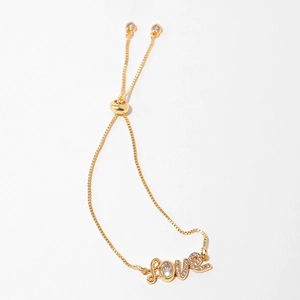Close-up of gold LOVE bracelet with zircon stones and adjustable sliding ball clasp