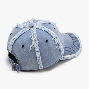 Adjustable washed denim baseball cap with distressed frayed edges and metal buckle details
