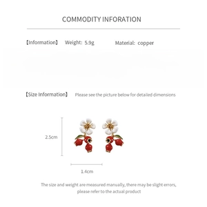 Detail view of floral berry earrings with size labels and material information
