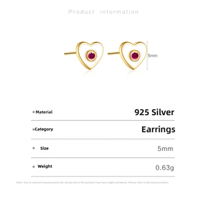 Detail view of 925 sterling silver heart studs with white enamel and red gemstone