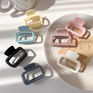 Close-up of matte square hair claw clips in assorted pastel colors for elegant styling