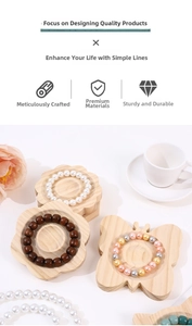 Detail of butterfly-shaped wooden jewelry tray showcasing assorted beaded bracelets