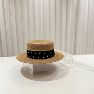 Detailed texture of woven boater hat with elegant black rhinestone band decoration