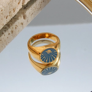 Macro shot of 18k gold plated ring featuring a blue enamel Saturn and star design