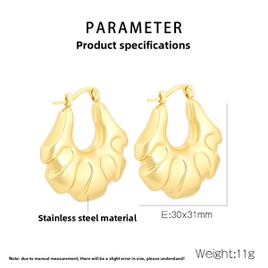 Detail of 18k gold plated hollow earrings with ripple texture and 30x31mm dimensions