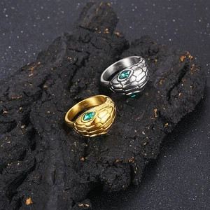 Punk style snake ring set in gold and silver steel with emerald green zircon eyes