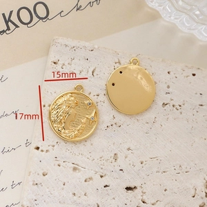Close-up of gold plated vintage round pendants with portrait relief and zircon stars