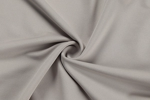 Close-up detail of grey textile fabric texture showing softness and high-density weave