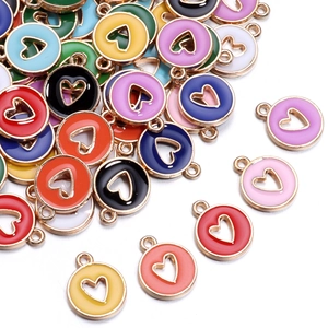 Close-up of colorful heart-shaped hollow charms made of alloy and enamel in multiple vibrant tones