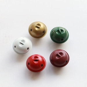 Macro detail of five-color matte metal bells with star cutouts for Christmas DIY