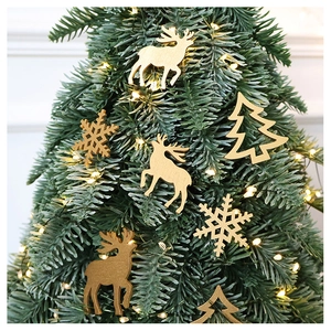 Detail of laser-cut wooden reindeer and snowflake ornaments on a lit Christmas tree