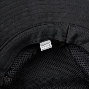Detail view of quick-dry sun hat showing breathable black mesh lining and polyester fabric