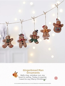 Detailed view of five gingerbread man ornaments hanging on a string with warm lights