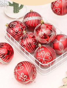 Gros plan de boules de Noël rouges avec motifs argentés dans un panier en métal blanc