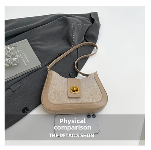 Detailed size comparison of beige woven underarm bag next to a smartphone device