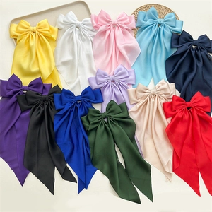 Elegant satin bow hair clip with long ribbon streamers in multiple vibrant colors