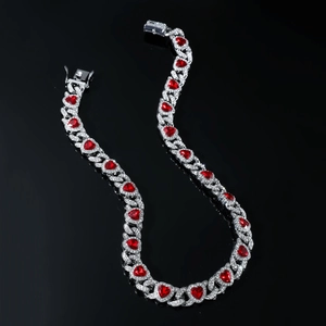 Iced out silver Cuban chain necklace with red heart pendants and shimmering diamonds
