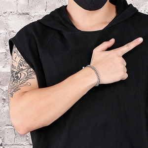 Minimalist silver Cuban chain bracelet for men with OT buckle worn on wrist by model