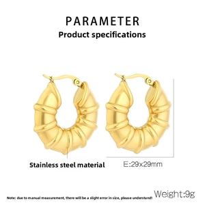 Macro detail of 18k gold plated hollow earrings with spiral texture and 29x29mm dimensions