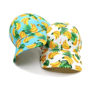 Detail of tropical banana leaf print on blue and white summer breathable baseball caps