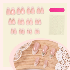 Pink press-on nails with golden French tip and 3D bowknot, includes file and glue