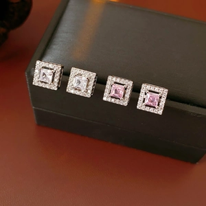 Detailed close-up of square zircon stud earrings in silver, clear and pink color options