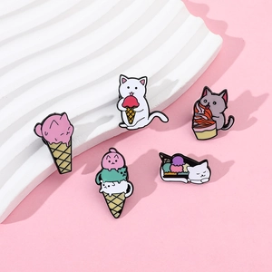 Close-up of five cute cartoon cat enamel pins featuring kittens eating ice cream cones