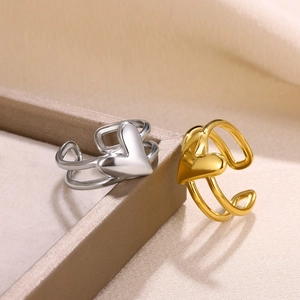 Close-up of gold and silver heart-shaped open rings with double-layered bands