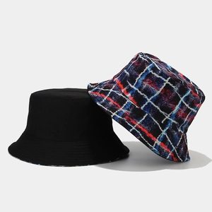 Detail showing reversible bucket hat with solid black and colorful graffiti plaid texture