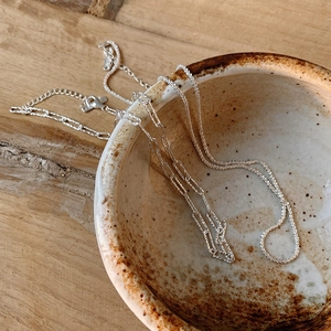 Detail of 925 sterling silver paperclip and shimmer chain necklaces with lobster clasp