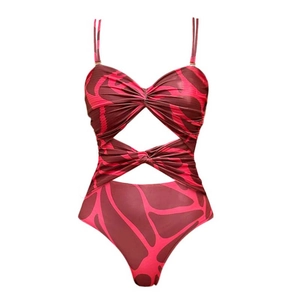 Detail view of pink and brown patterned cutout monokini with knot waist and high leg cut