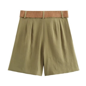Detail view of olive green high-waisted shorts featuring a brown woven belt accessory