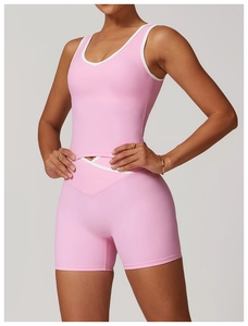 Detailed close-up of pink sports set with white contrast trim and V-shaped waist yoga shorts