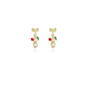 Detail view of gold bow-shaped drop earrings with green leaves and red bead accents