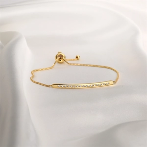 Detailed view of adjustable gold bracelet with sparkling white zircon stones inlay