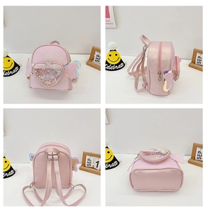Detail view of pink sequin kids backpack with heart compartment and wing design