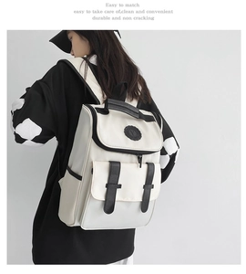 Detailed back view of a beige nylon backpack with double buckles in a casual style
