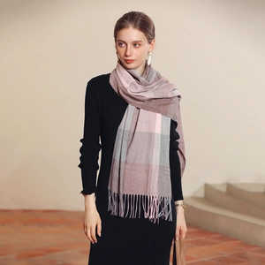 Fashionable pink and grey plaid cashmere scarf with soft tassels worn by a model