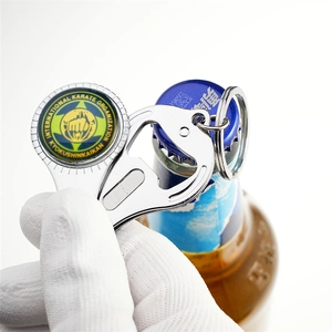 Silver metal bottle opener keychain with karate emblem shown opening a beer bottle