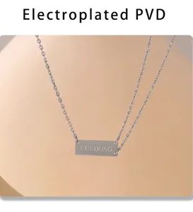 Detailed macro of silver PVD plated rectangular pendant with custom letter engraving