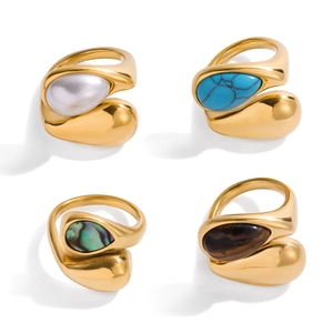 Titanium steel rings with natural stone inlays in gold finish on white background