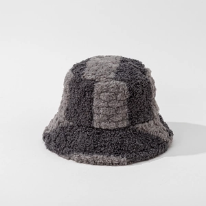 Close-up of thick plush checkerboard bucket hat with grey and black patchwork texture