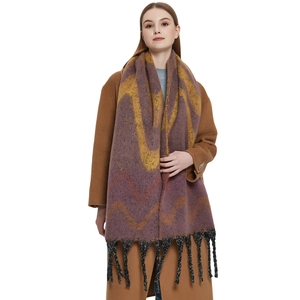 Thick faux mohair scarf with purple wave patterns and black tassels on model