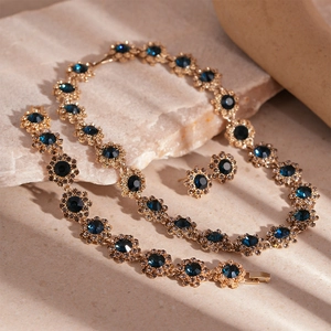 Vintage gold flower jewelry set with dark blue crystals including necklace and earrings