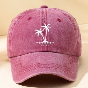 Close-up of a vintage red washed cotton baseball cap featuring white palm tree embroidery